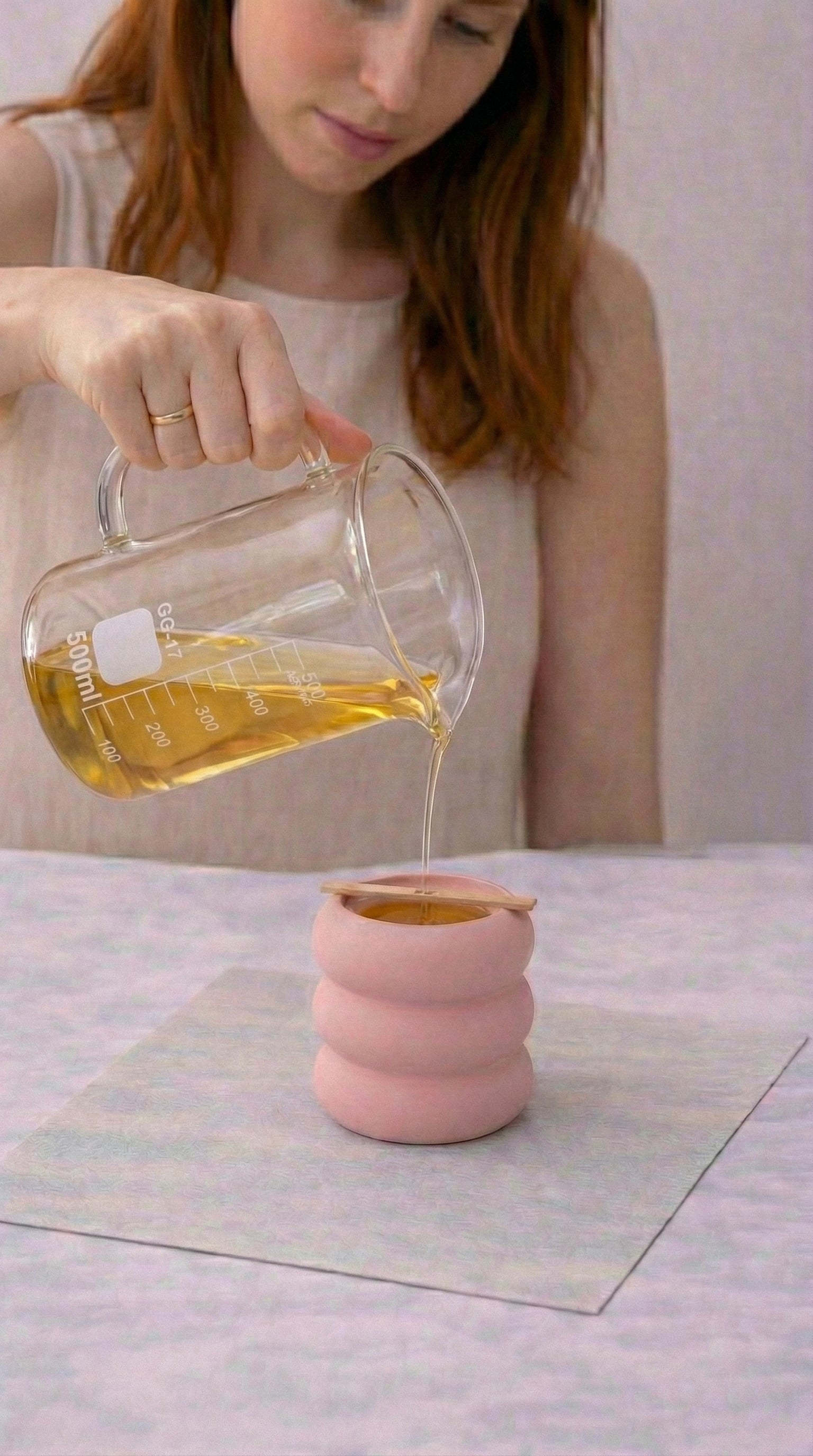 Pouring wax into a handmade candle vessel during a private candle-making workshop in Orlando.