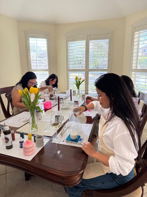 Guests pouring wax and creating handmade candles during a Set & Melt candle making workshop experience in Orlando.