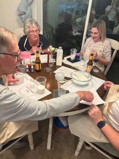 Private candle making workshop by Set & Melt where guests create handmade candles together at a home table using custom vessels and soy wax.