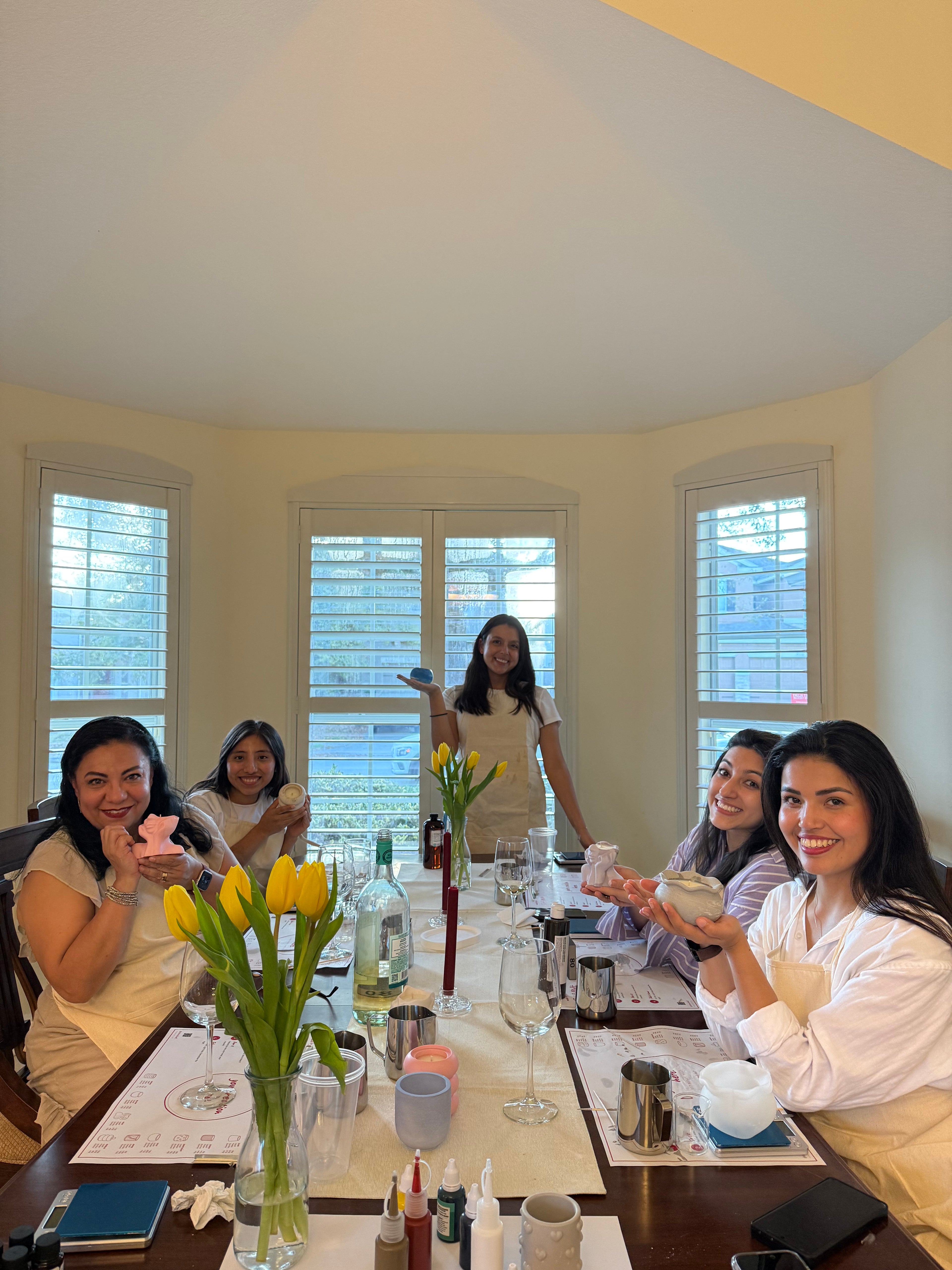 Group enjoying a private candle making workshop at home with Set & Melt creating custom candles together.